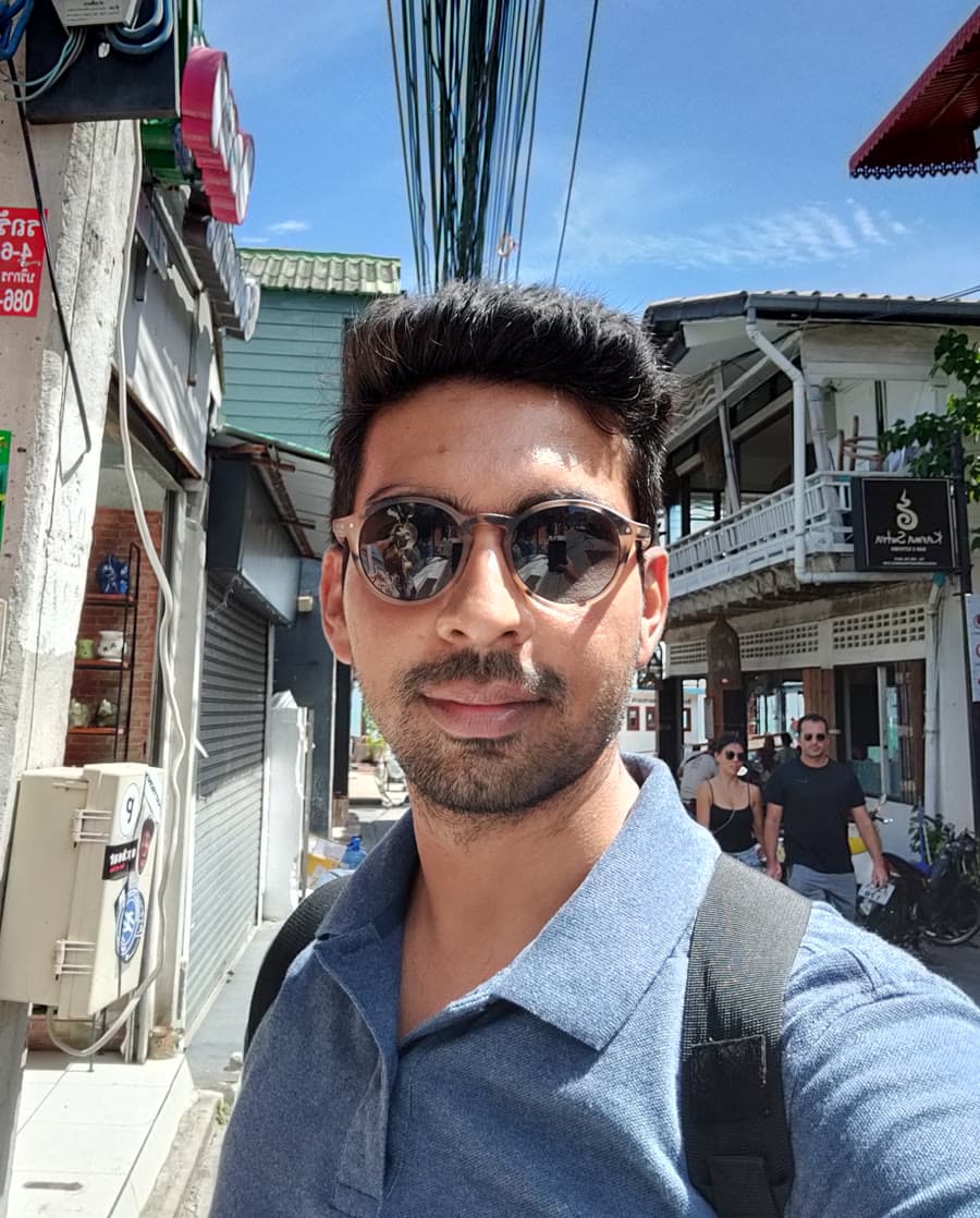 Dhruv outdoors on a sunny street